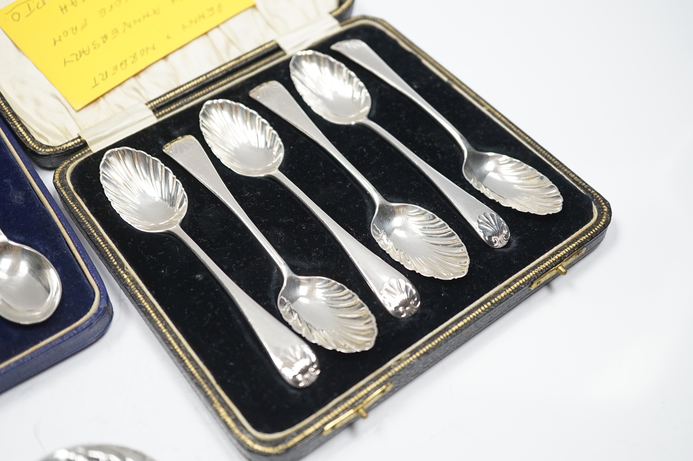 Two cased sets of six silver teaspoons, including Old English shell pattern by James Dixon & Sons, Sheffield, 1893 and Robert Pringle & Sons, Sheffield 1941, together with two silver mounted glass toilet jars and a sterl